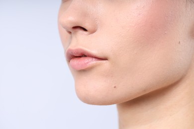 Photo of Woman with normal skin on light background, closeup. Space for text