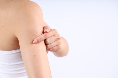 Photo of Woman with normal skin on light background, closeup. Space for text