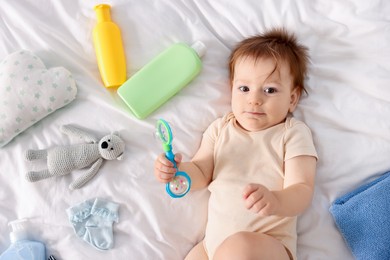 Photo of Cute baby and different accessories on bed, top view