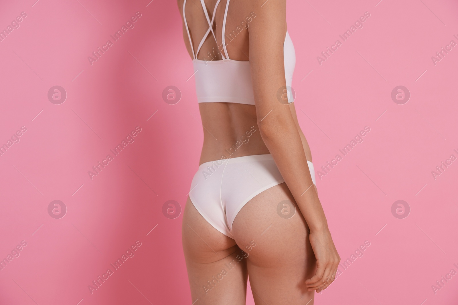 Photo of Woman with slim body on pink background, closeup