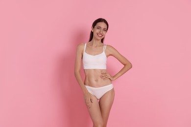 Photo of Woman with slim body on pink background