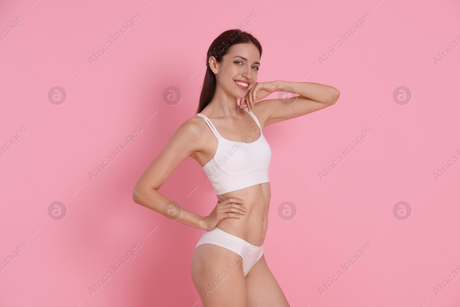 Photo of Woman with slim body on pink background