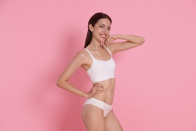 Photo of Woman with slim body on pink background