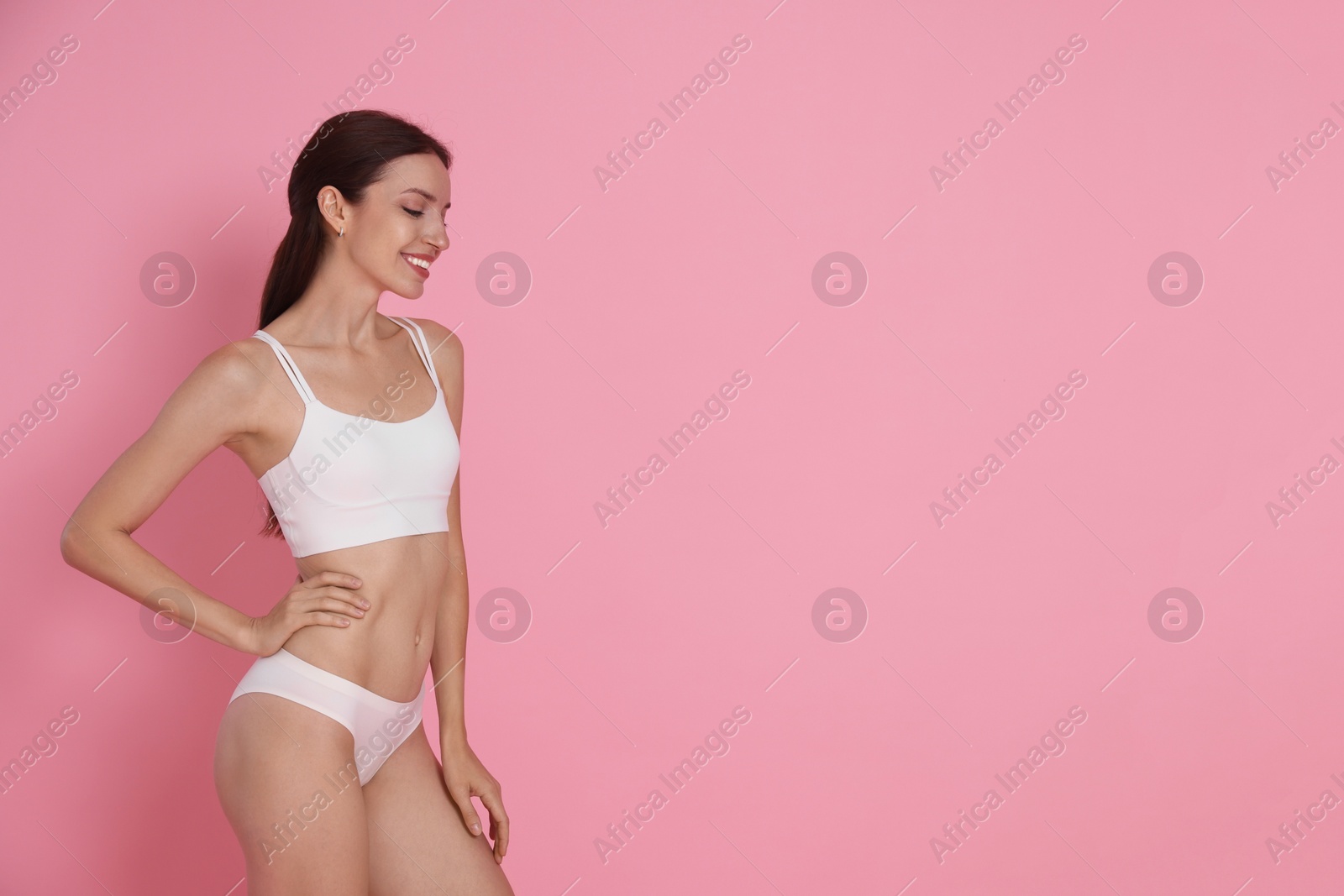 Photo of Woman with slim body on pink background, space for text