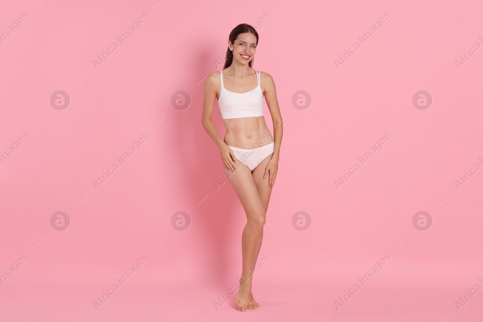 Photo of Woman with slim body on pink background