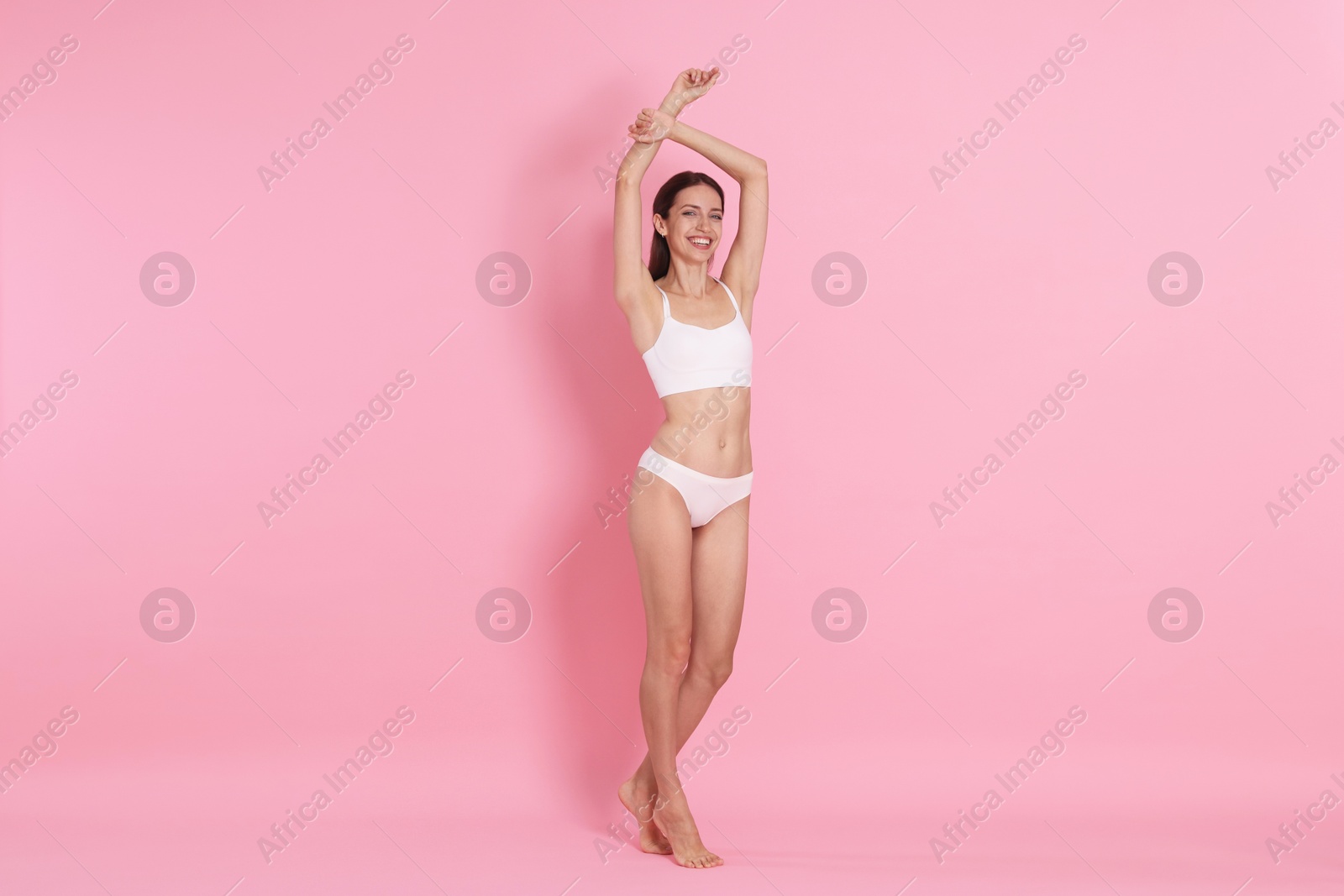 Photo of Woman with slim body on pink background