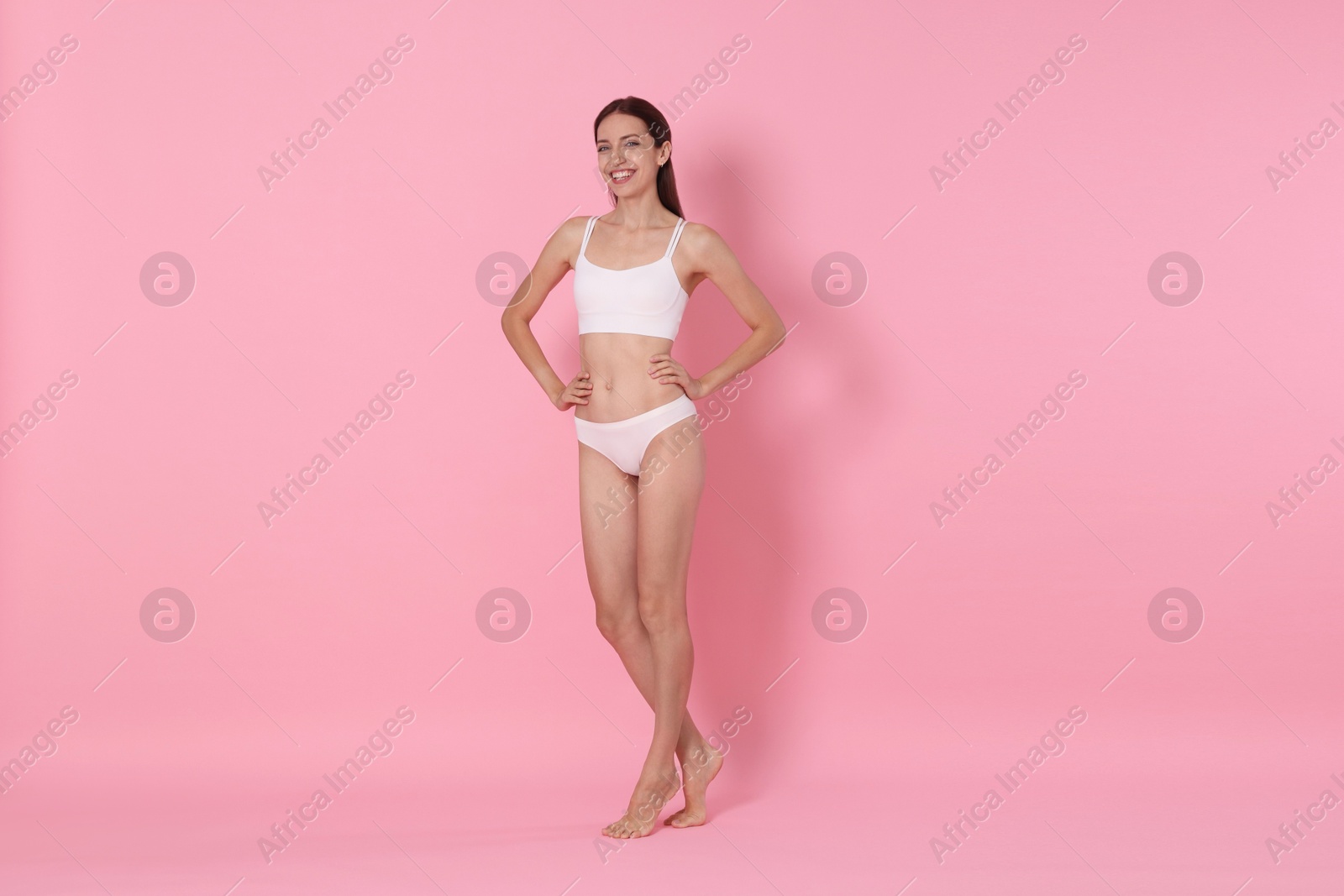 Photo of Woman with slim body on pink background