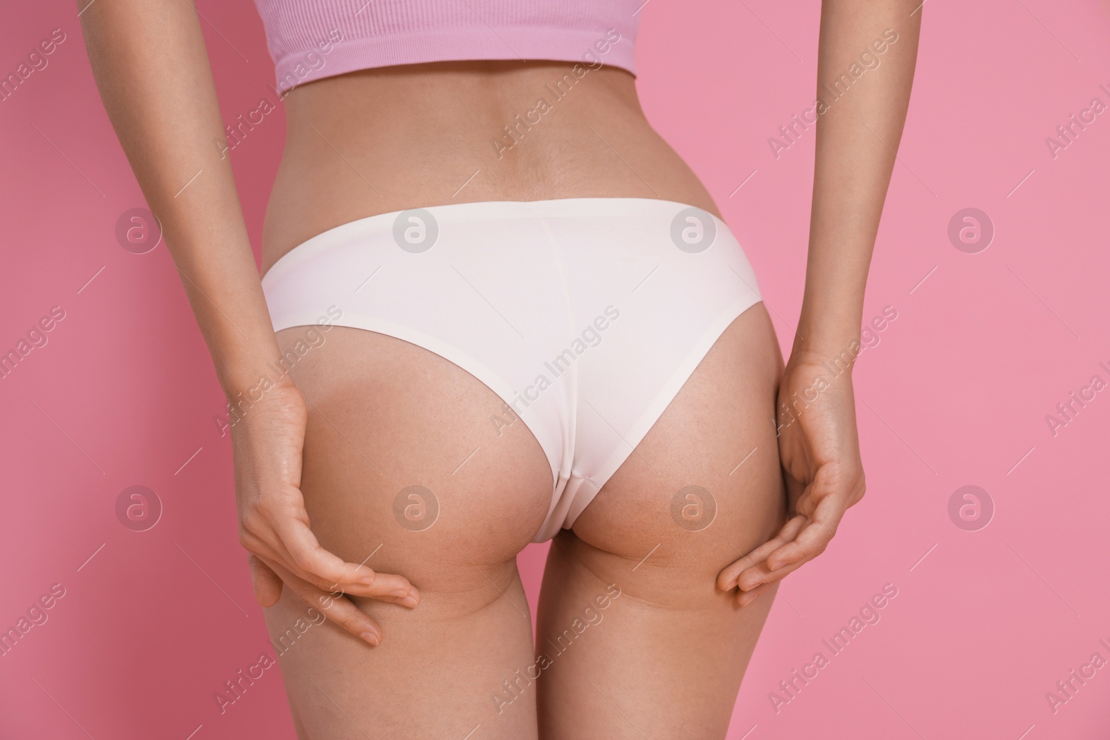 Photo of Woman with slim body on pink background, closeup
