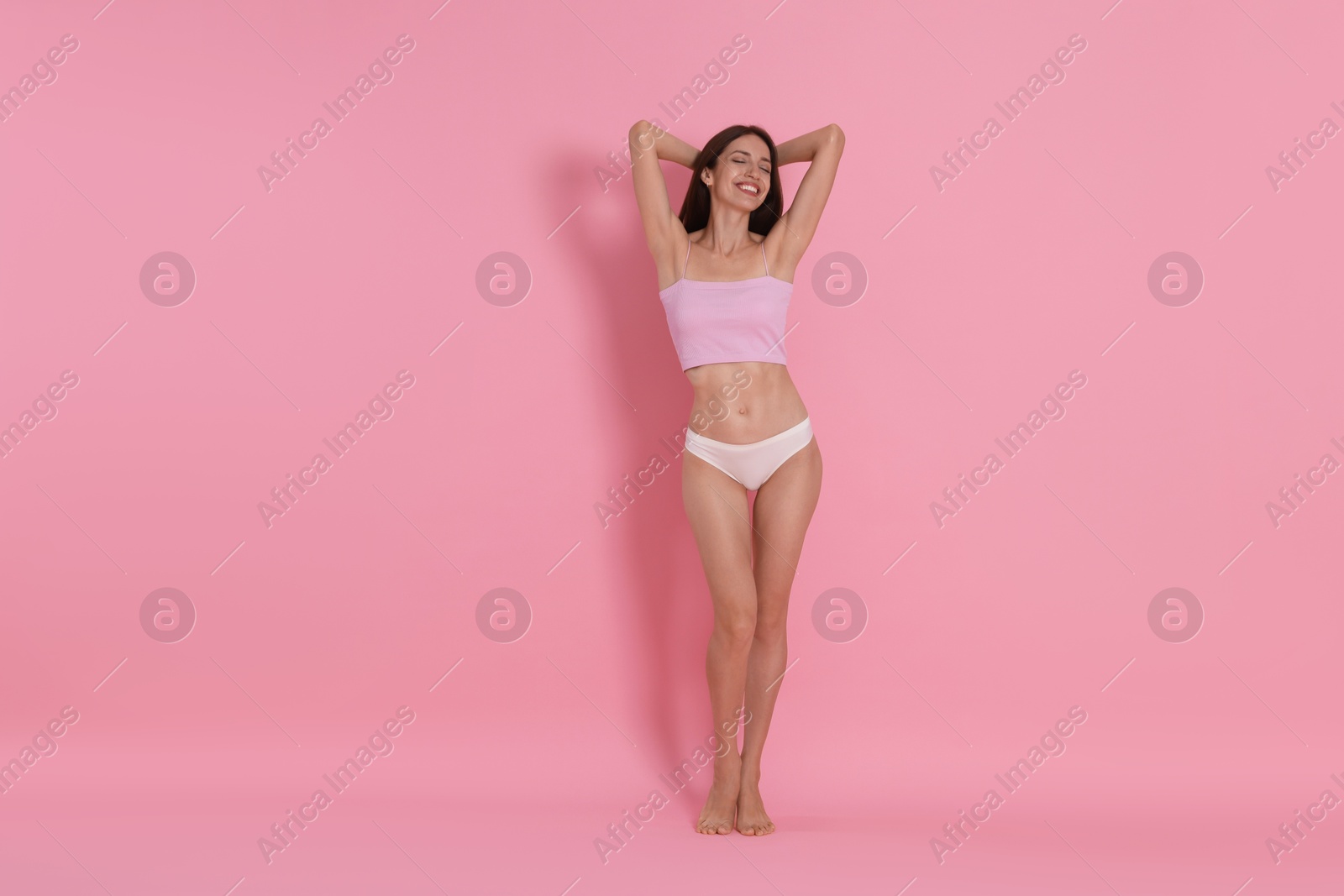 Photo of Woman with slim body on pink background