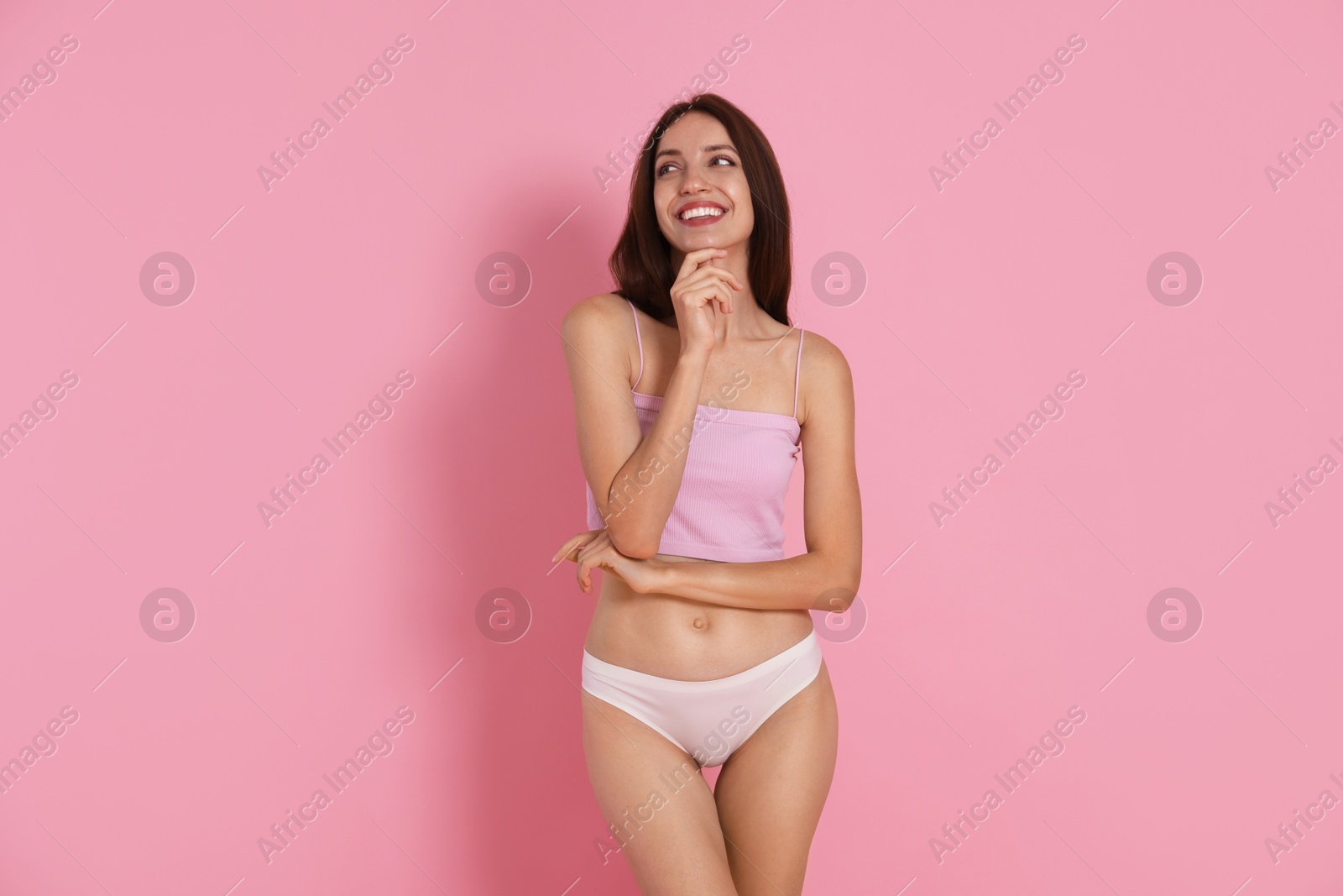 Photo of Woman with slim body on pink background