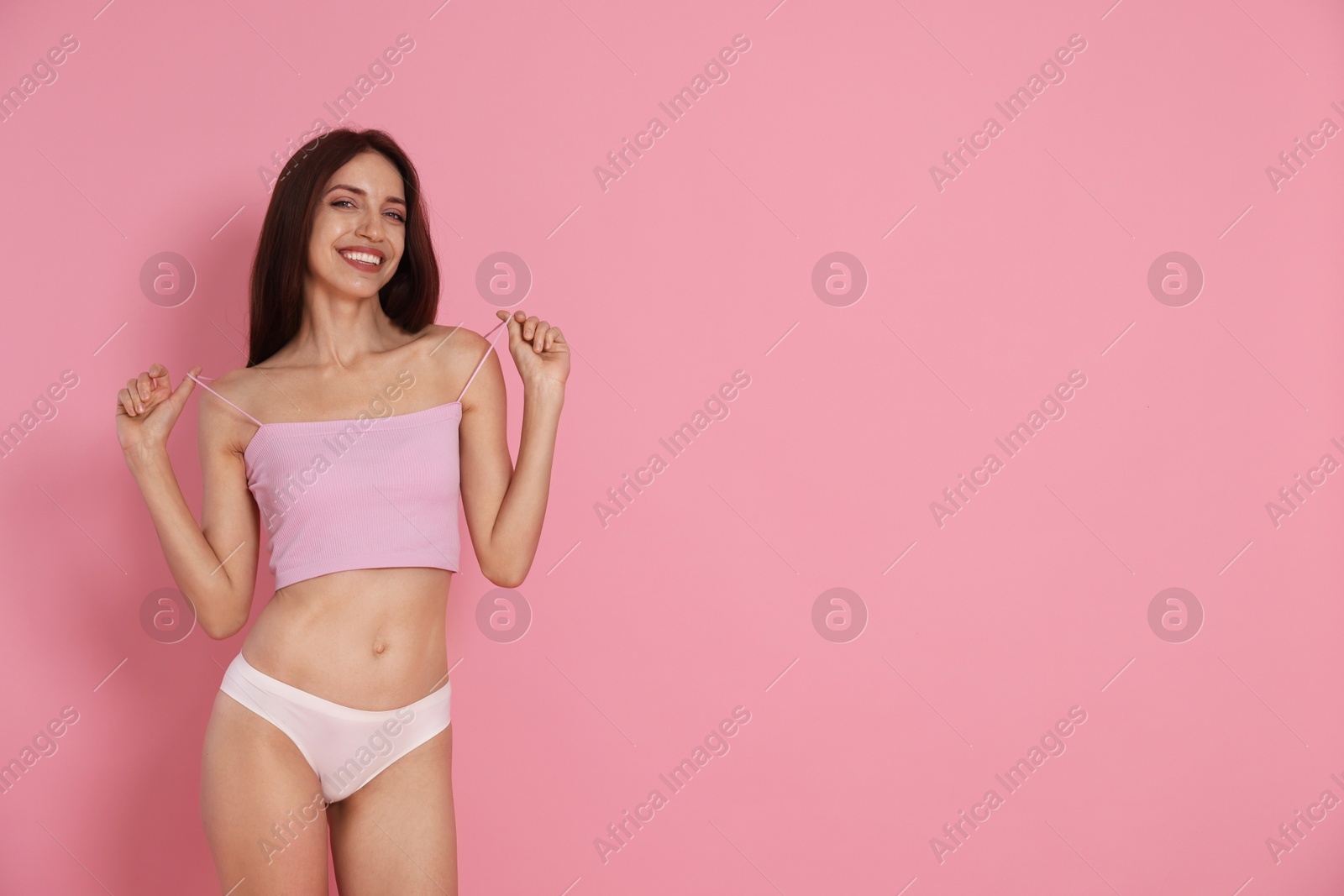 Photo of Woman with slim body on pink background, space for text