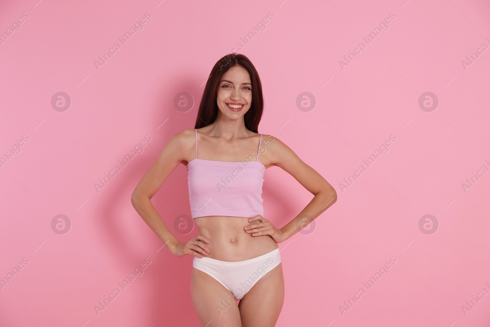 Photo of Woman with slim body on pink background