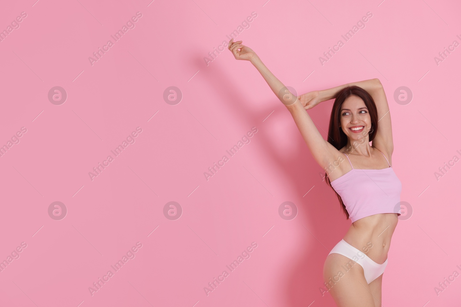 Photo of Woman with slim body on pink background, space for text