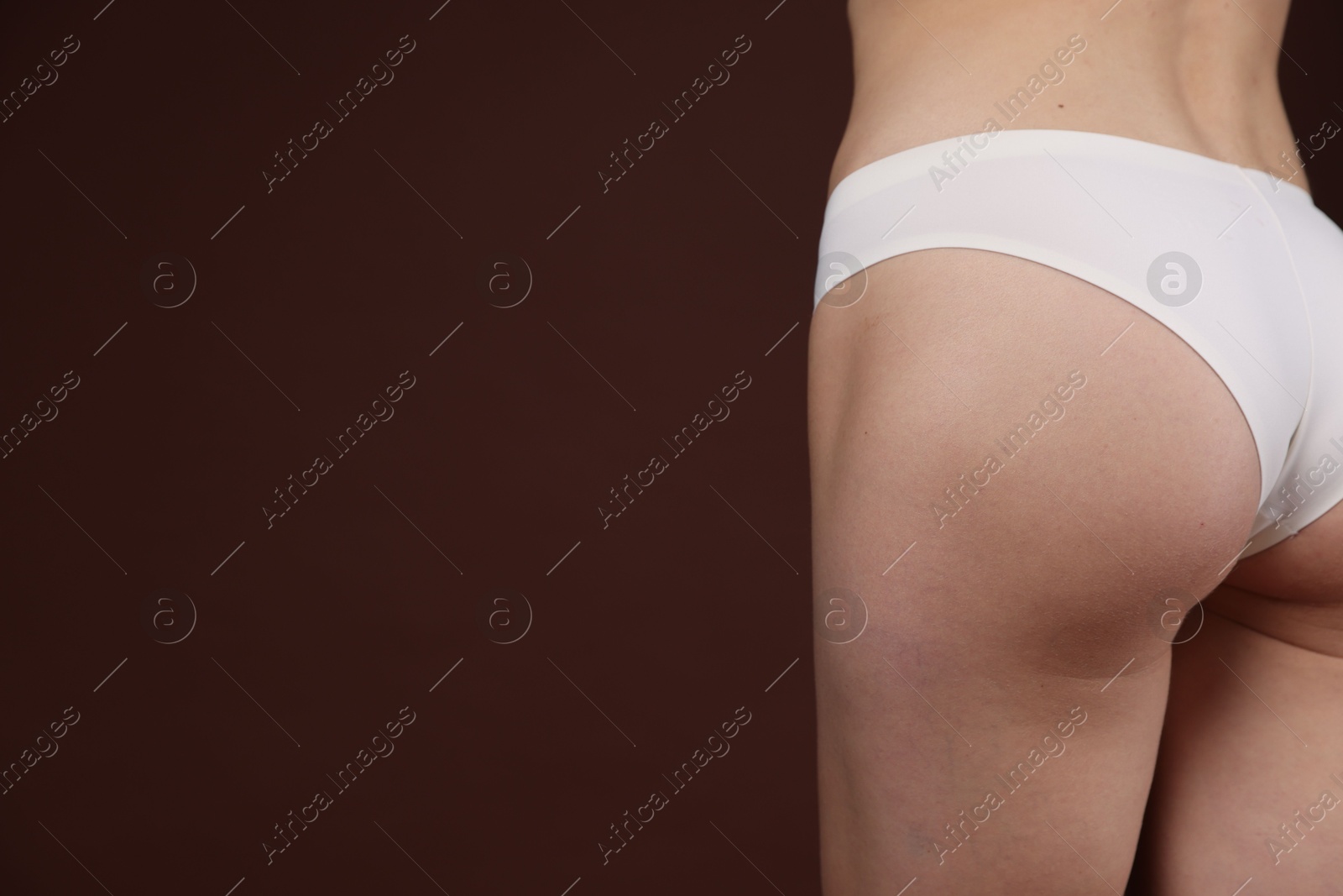 Photo of Woman with slim body on brown background, closeup. Space for text