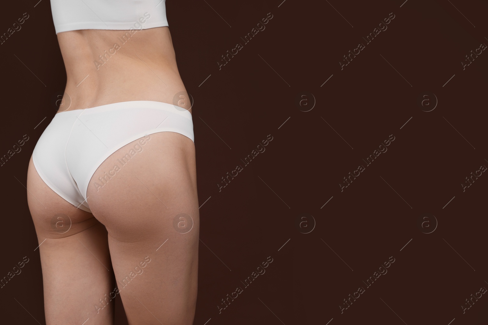 Photo of Woman with slim body on brown background, closeup. Space for text