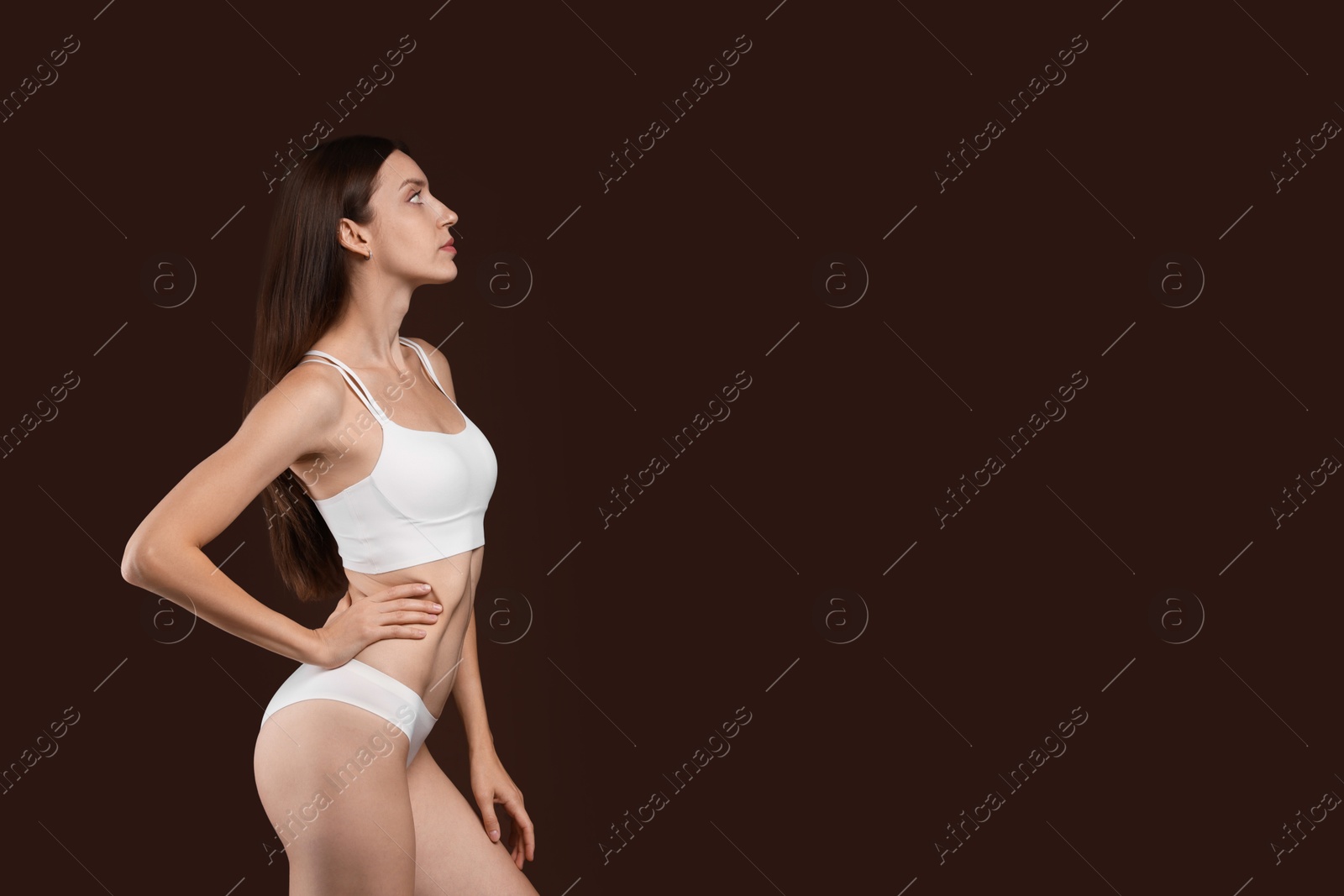 Photo of Woman with slim body on brown background, space for text
