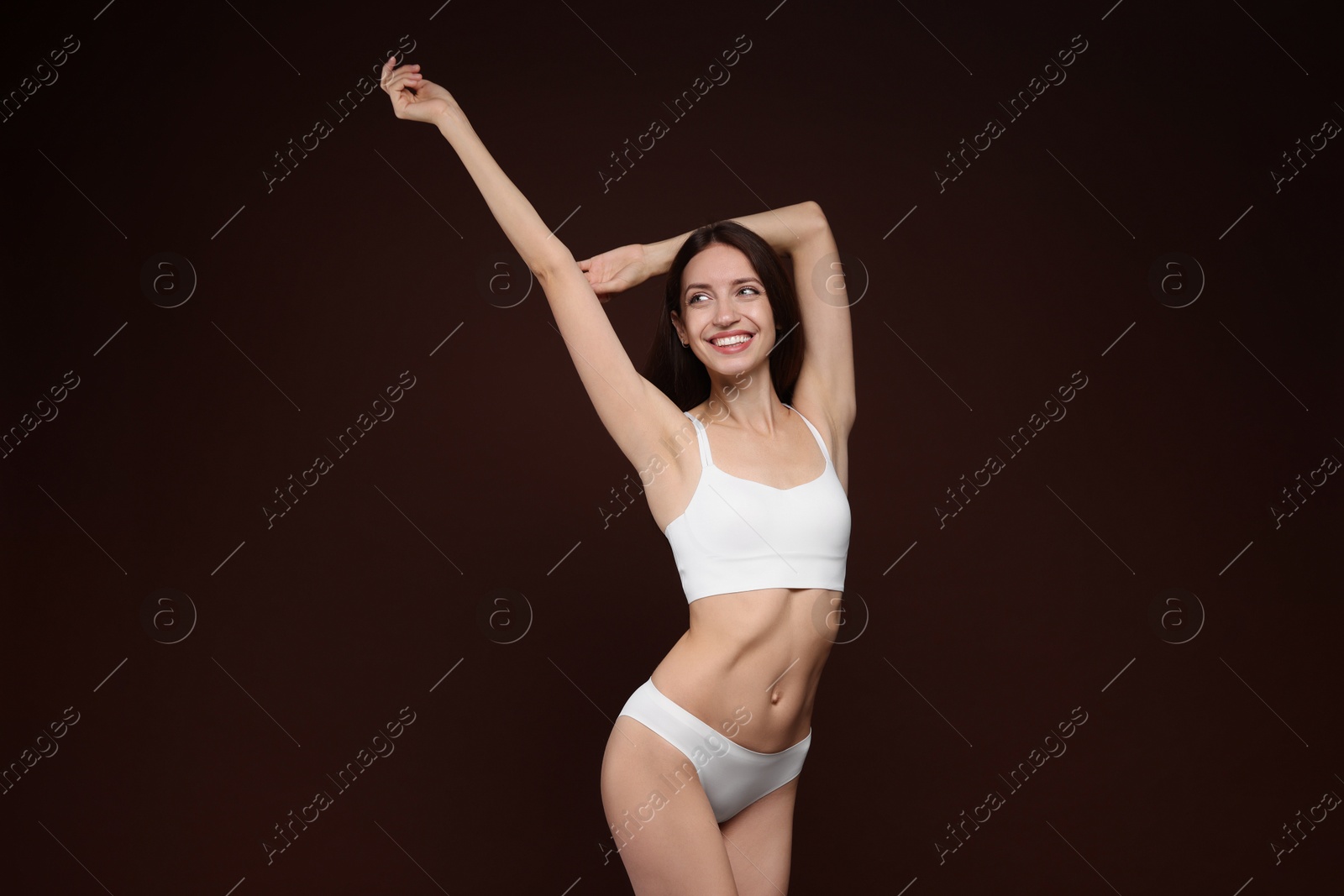 Photo of Woman with slim body on brown background