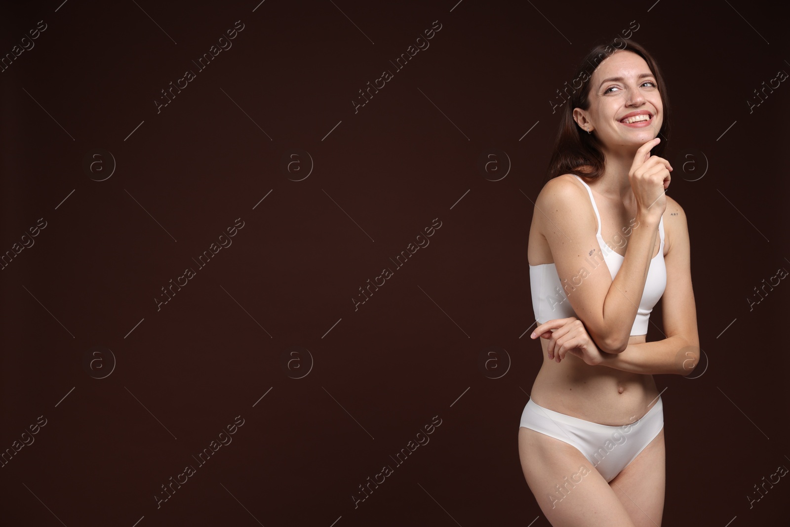 Photo of Woman with slim body on brown background, space for text