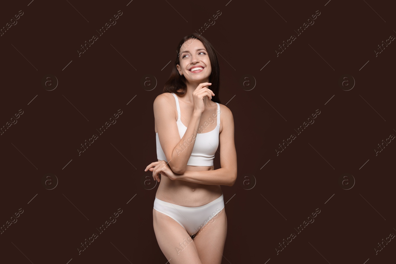 Photo of Woman with slim body on brown background