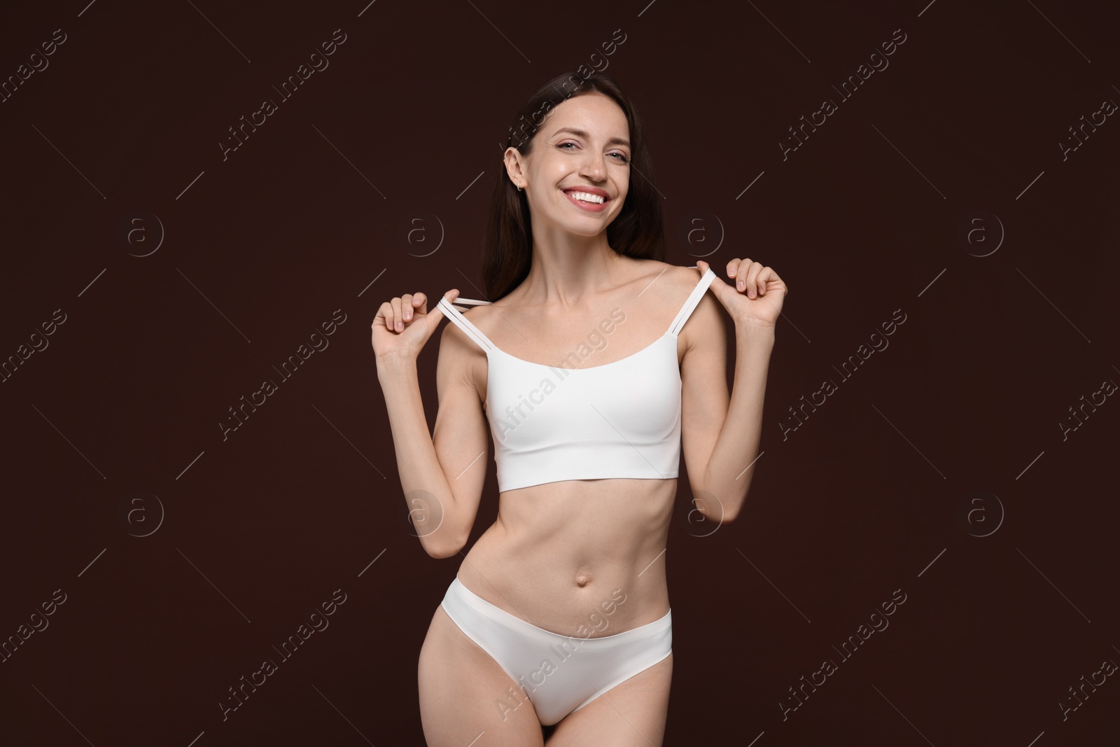 Photo of Woman with slim body on brown background