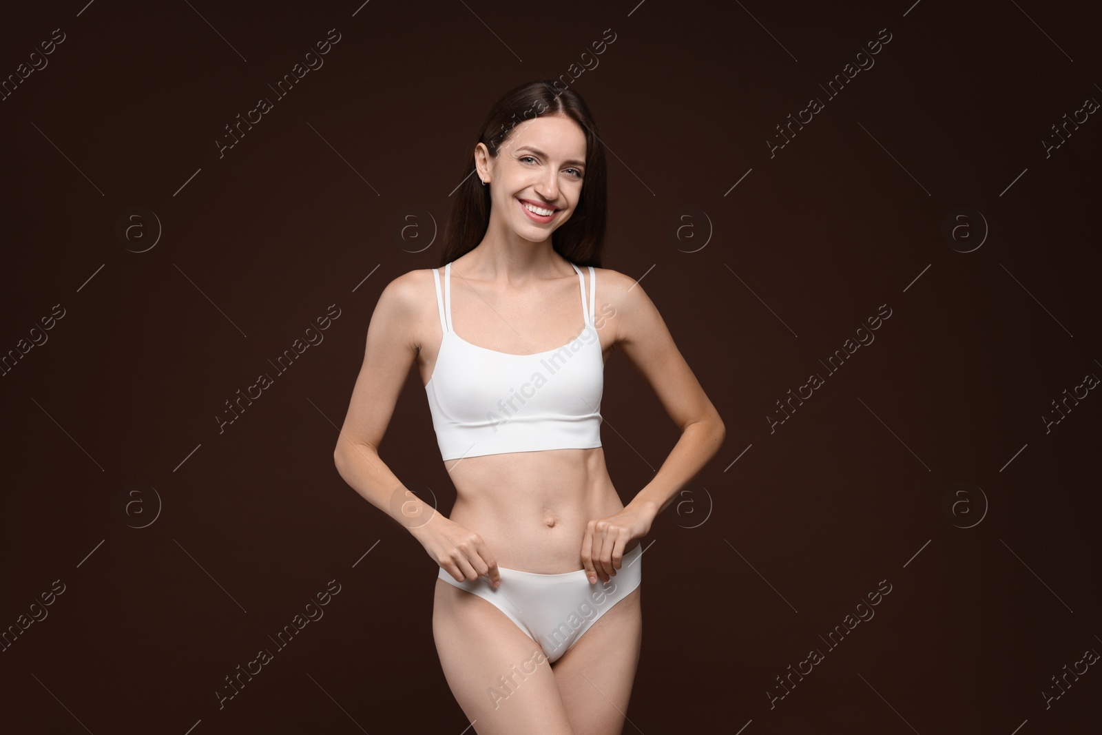 Photo of Woman with slim body on brown background