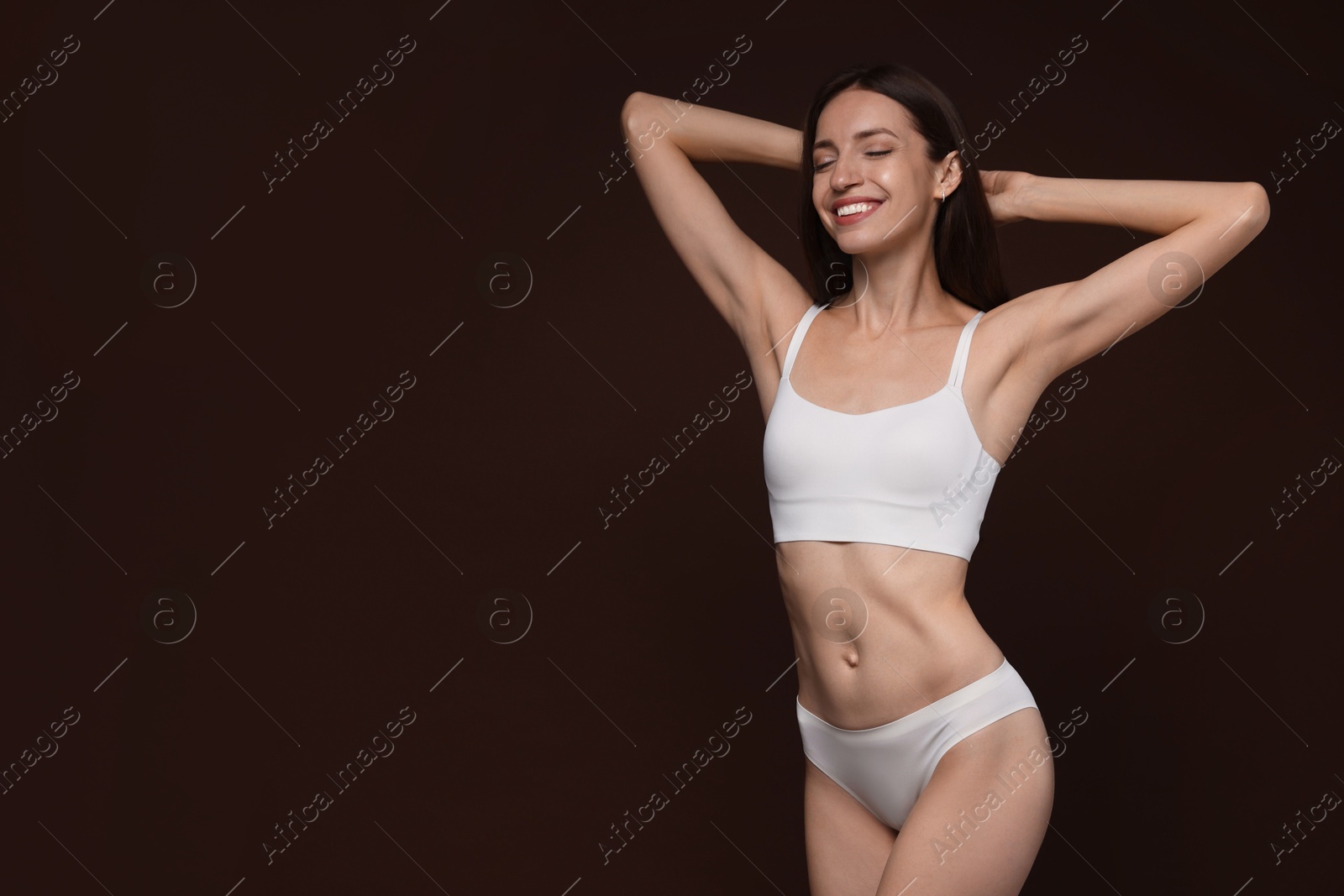 Photo of Woman with slim body on brown background, space for text
