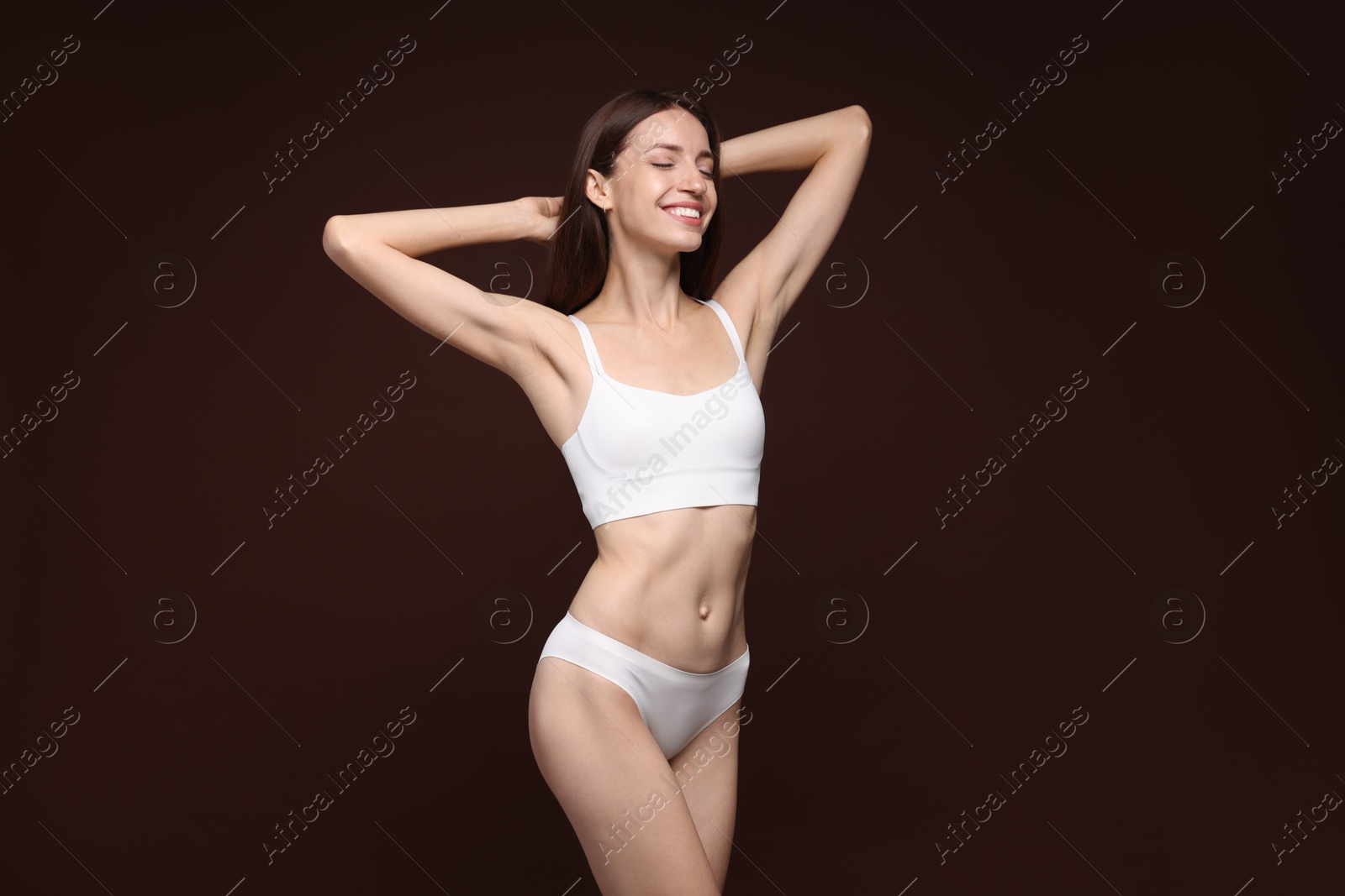 Photo of Woman with slim body on brown background