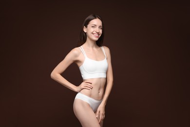 Photo of Woman with slim body on brown background