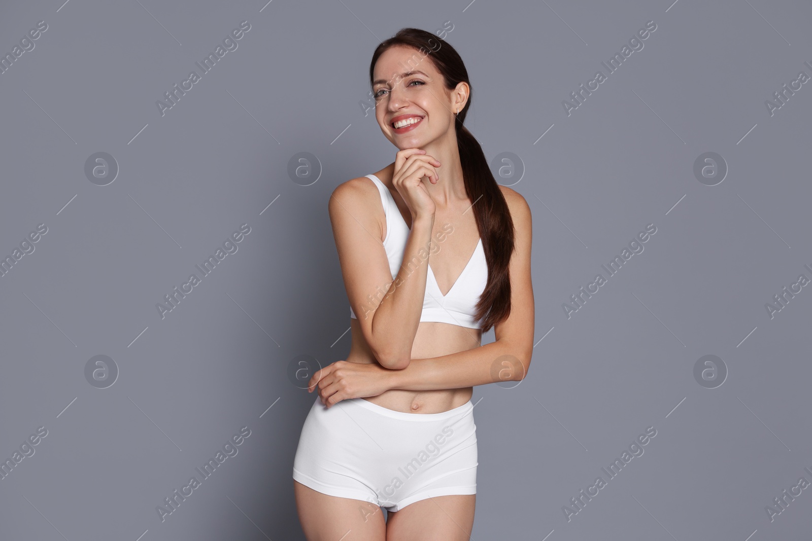 Photo of Woman with slim body on grey background