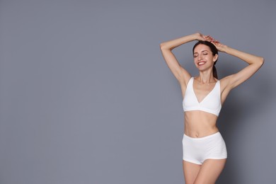 Photo of Woman with slim body on grey background, space for text