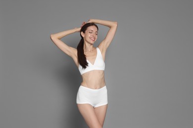 Photo of Woman with slim body on grey background