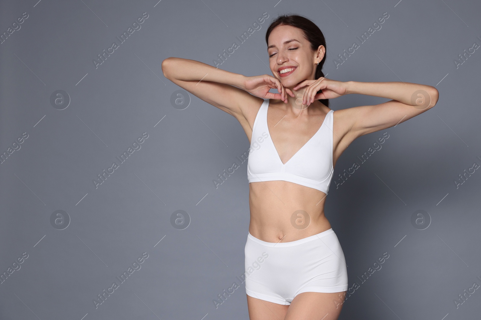 Photo of Woman with slim body on grey background, space for text