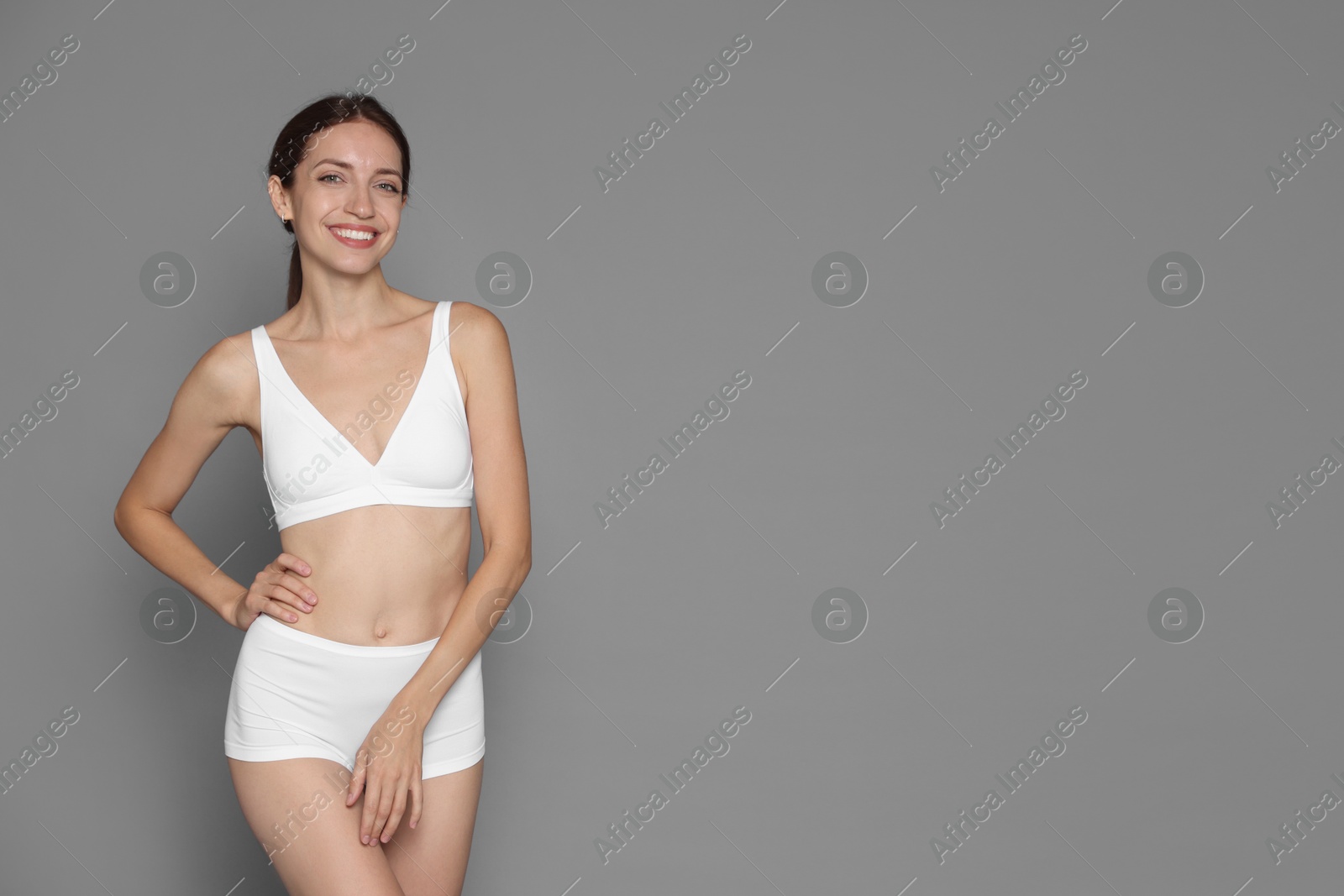 Photo of Woman with slim body on grey background, space for text