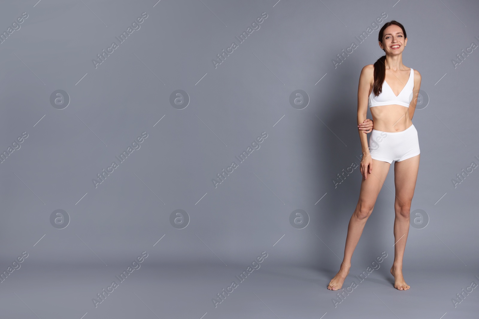 Photo of Woman with slim body on grey background, space for text