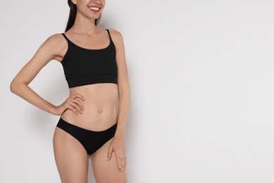 Photo of Woman with slim body on white background, closeup. Space for text