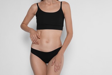 Photo of Woman with slim body on white background, closeup. Space for text