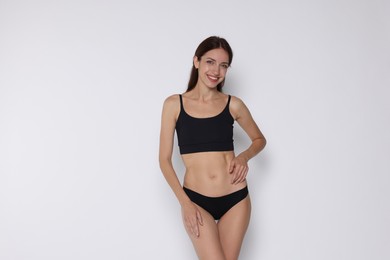 Photo of Woman with slim body on white background