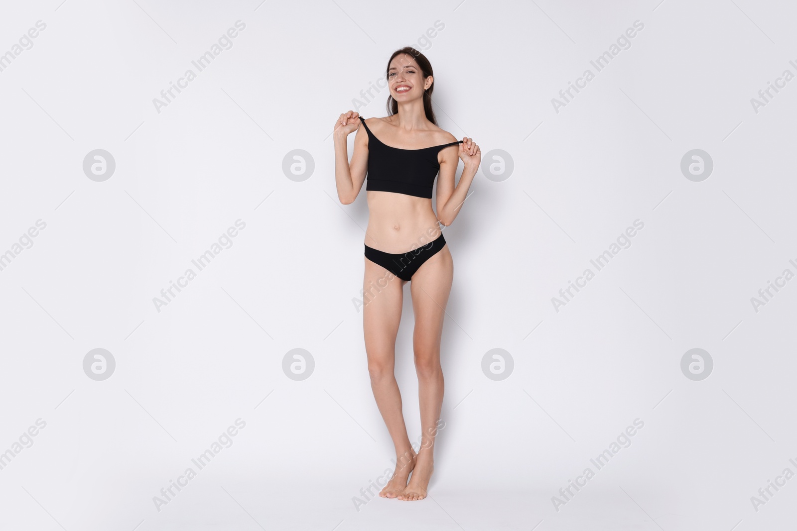 Photo of Woman with slim body on white background