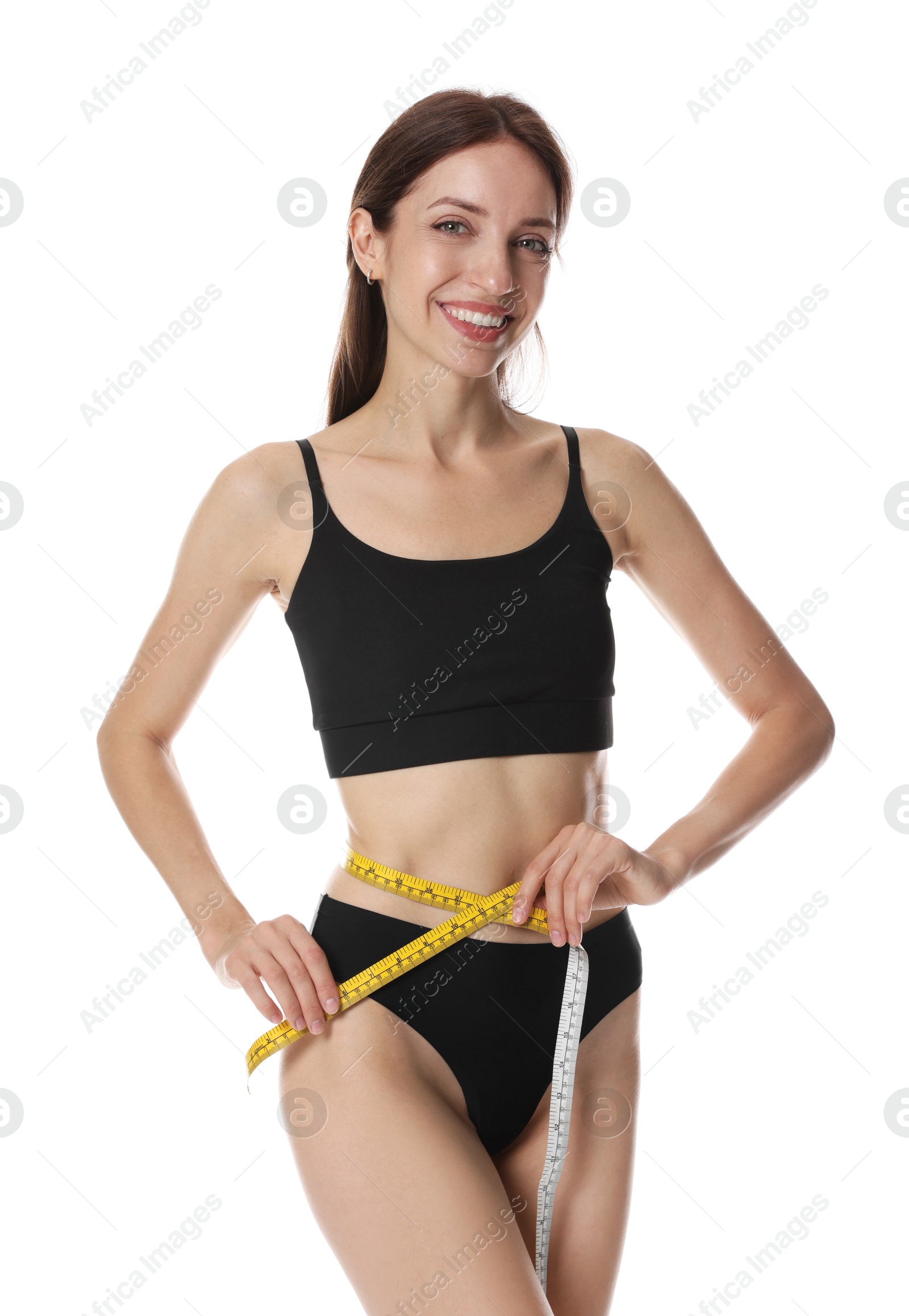 Photo of Woman with slim body measuring waist circumference on white background