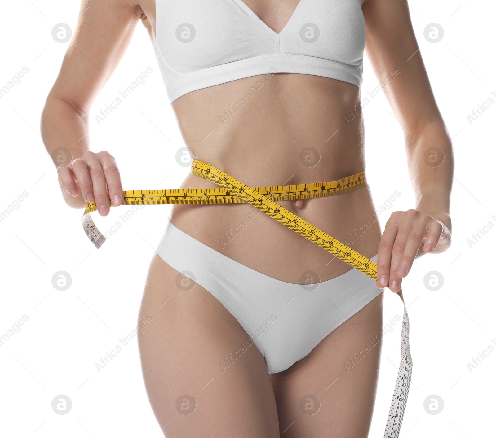 Photo of Woman with slim body measuring waist circumference on white background, closeup