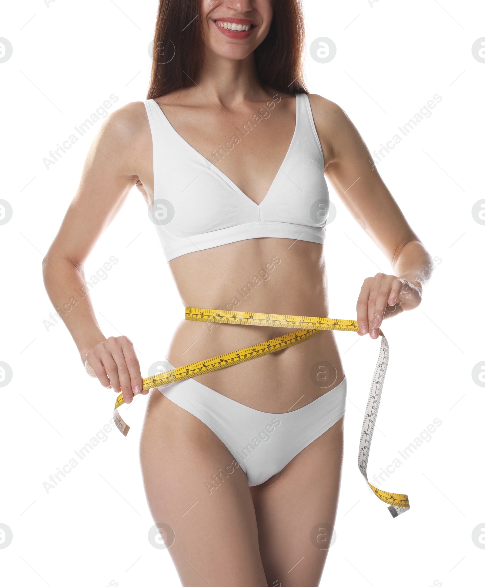 Photo of Woman with slim body measuring waist circumference on white background, closeup