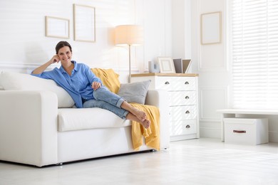 Photo of Positive woman on sofa at home. Space for text