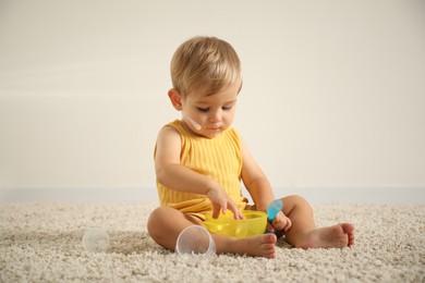 Photo of Cute baby with cream on his body playing at home