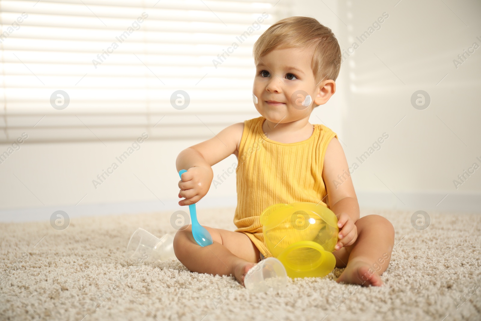 Photo of Cute baby with cream on his body playing at home. Space for text