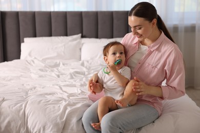 Photo of Mother and baby with cream on his face at home. Space for text