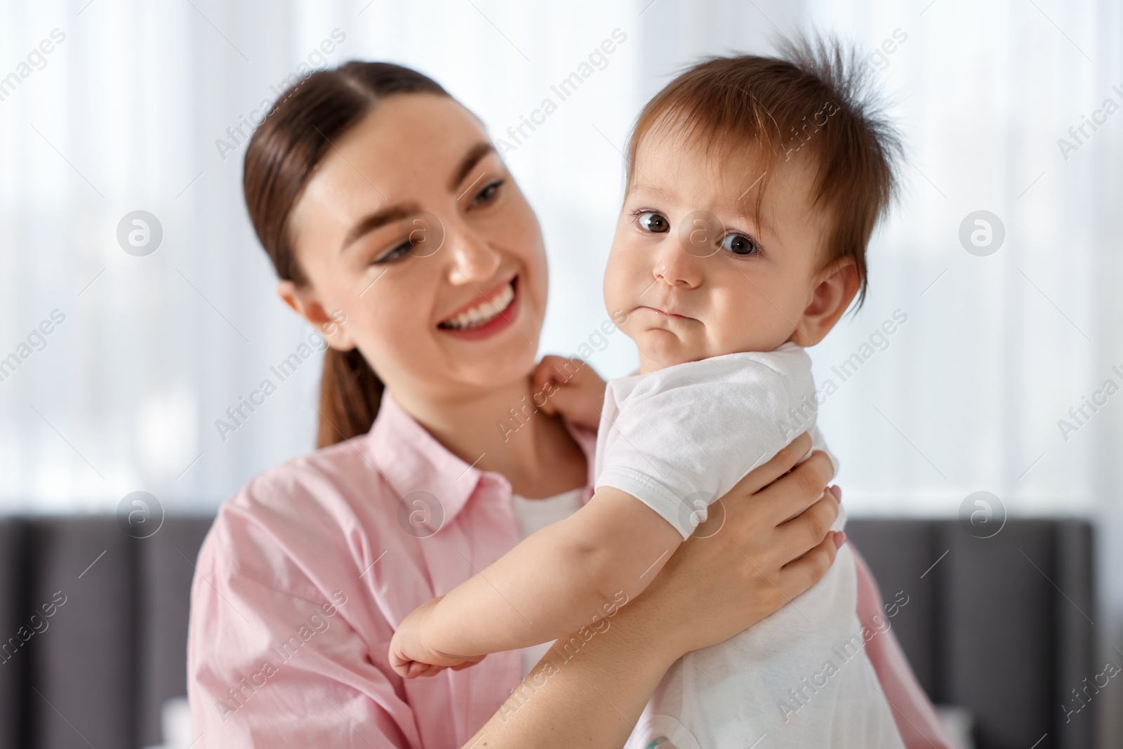 Photo of Mother with her cute baby at home