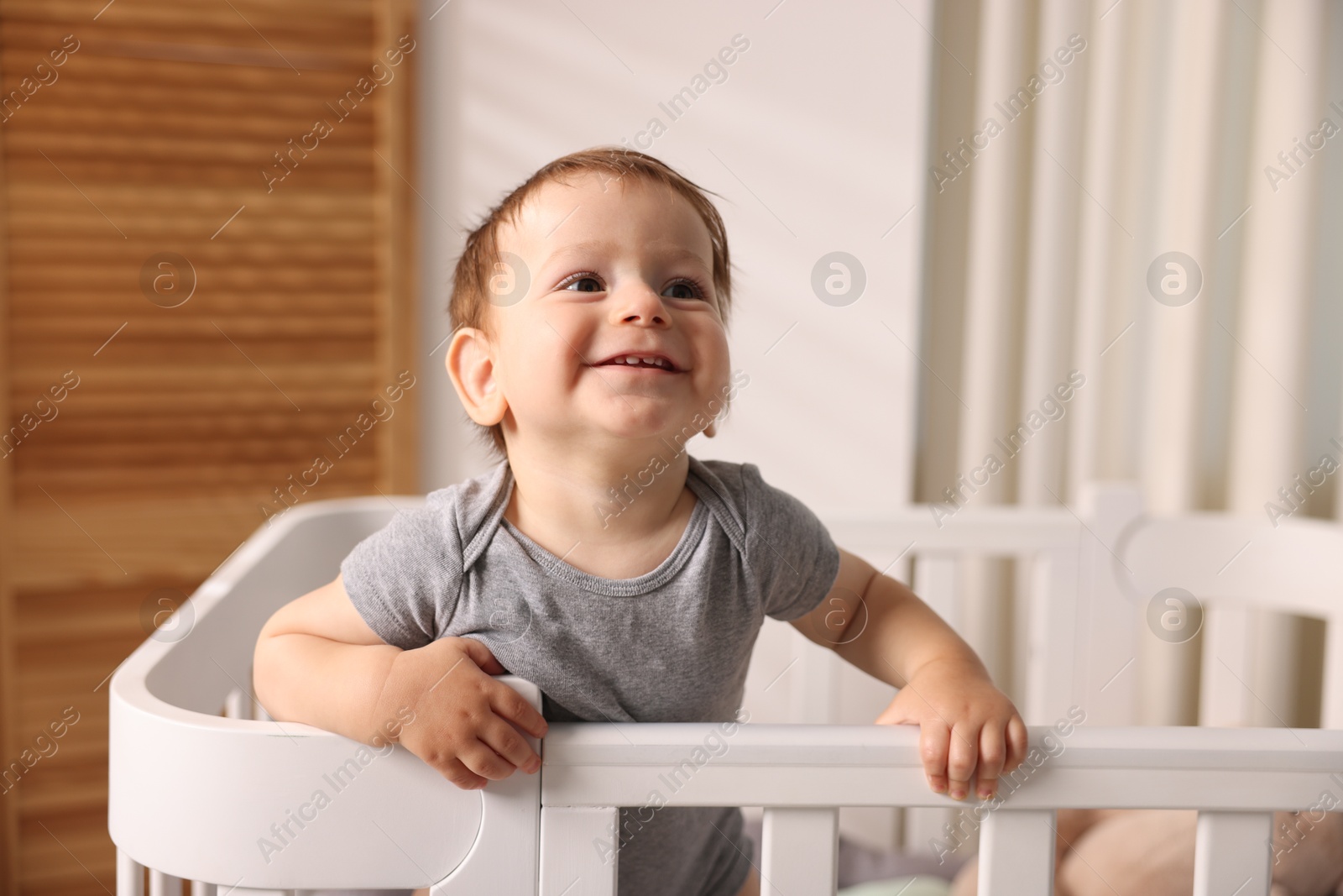 Photo of Cute little baby in crib at home