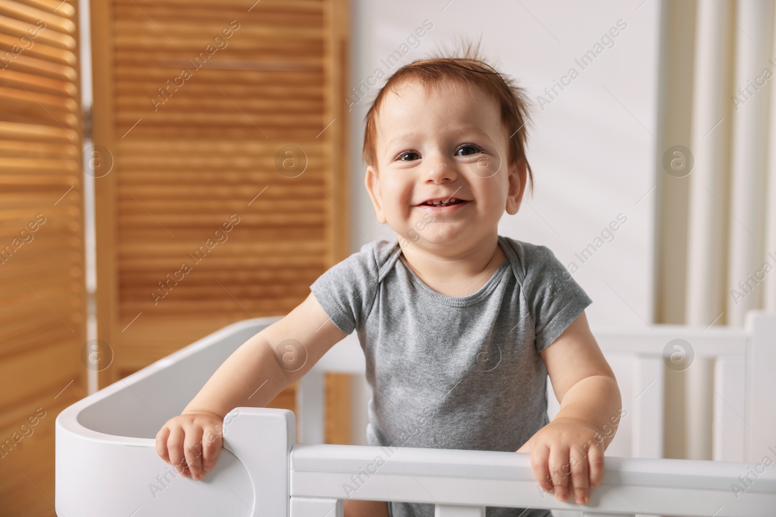 Photo of Cute little baby in crib at home