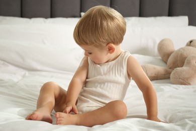 Photo of Cute baby with cream on his arm at home