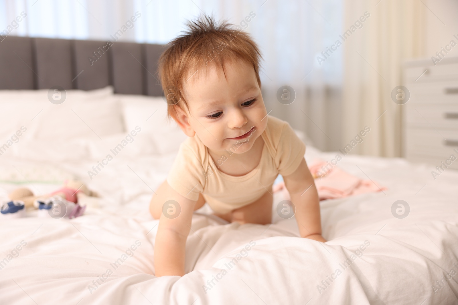 Photo of Cute little baby on bed at home